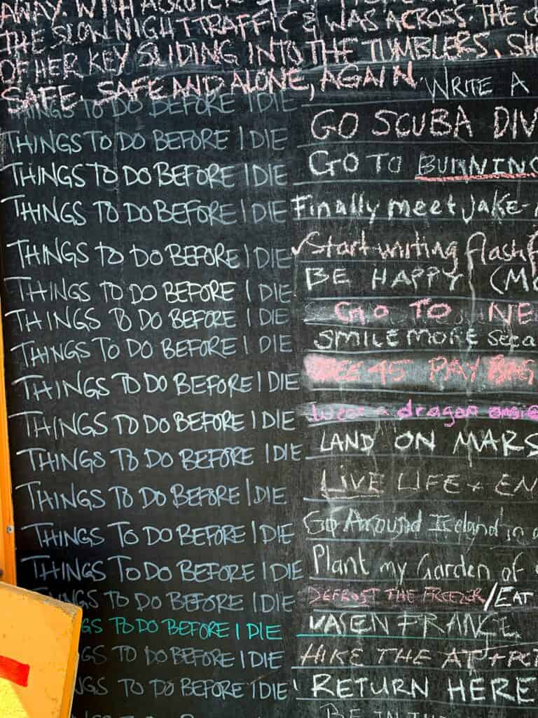 A close-up of a chalkboard with "Things to do Before I Die" written in chalk and various entries to the right.
